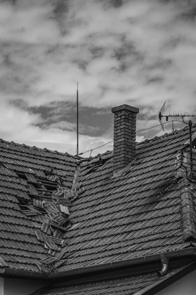 Storm-damaged roof tiles needing emergency repair